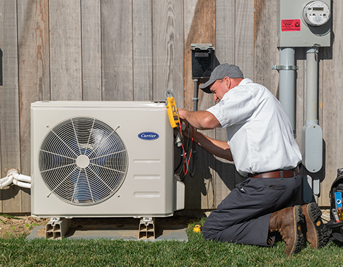 RSC HVAC technician servicing a residential air conditioner unit.